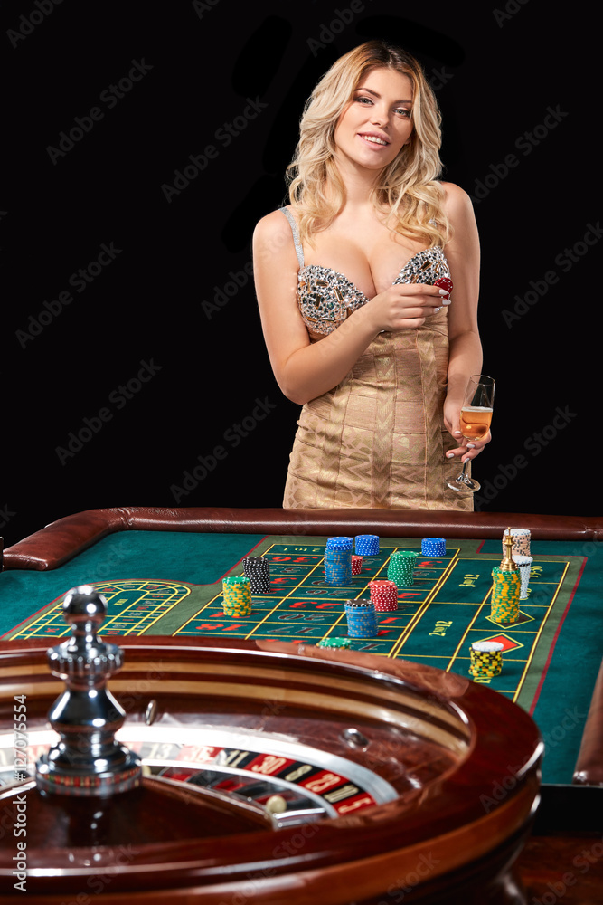 woman in a smart dress plays roulette. woman in a smart dress plays roulette.