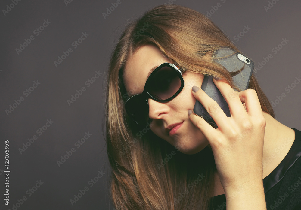 Young woman with a mobile phone toned in vintage color Young woman with a mobile phone toned in vintage color