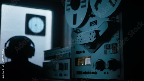 medium shot of an agent listening to a tape recorder