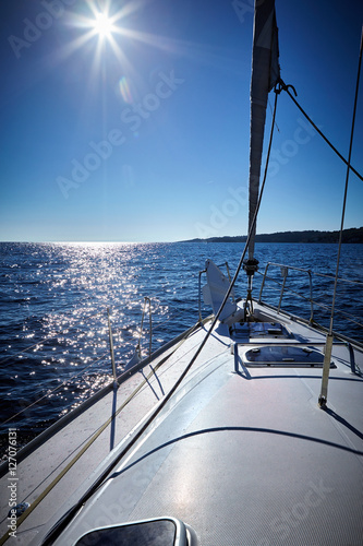 Front part of a sailboat, set on full sails to the sea © fotoru