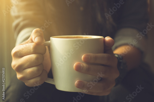 Young hipster woman hands holding coffee cup