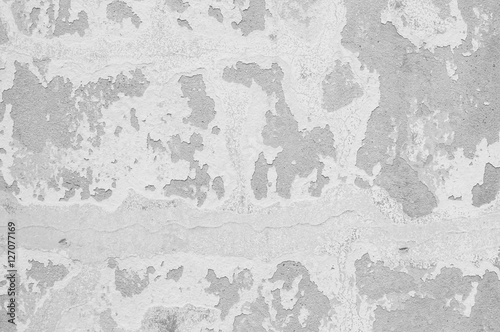 Closeup pale color and peeling of painted green cement wall textured background in black and white tone