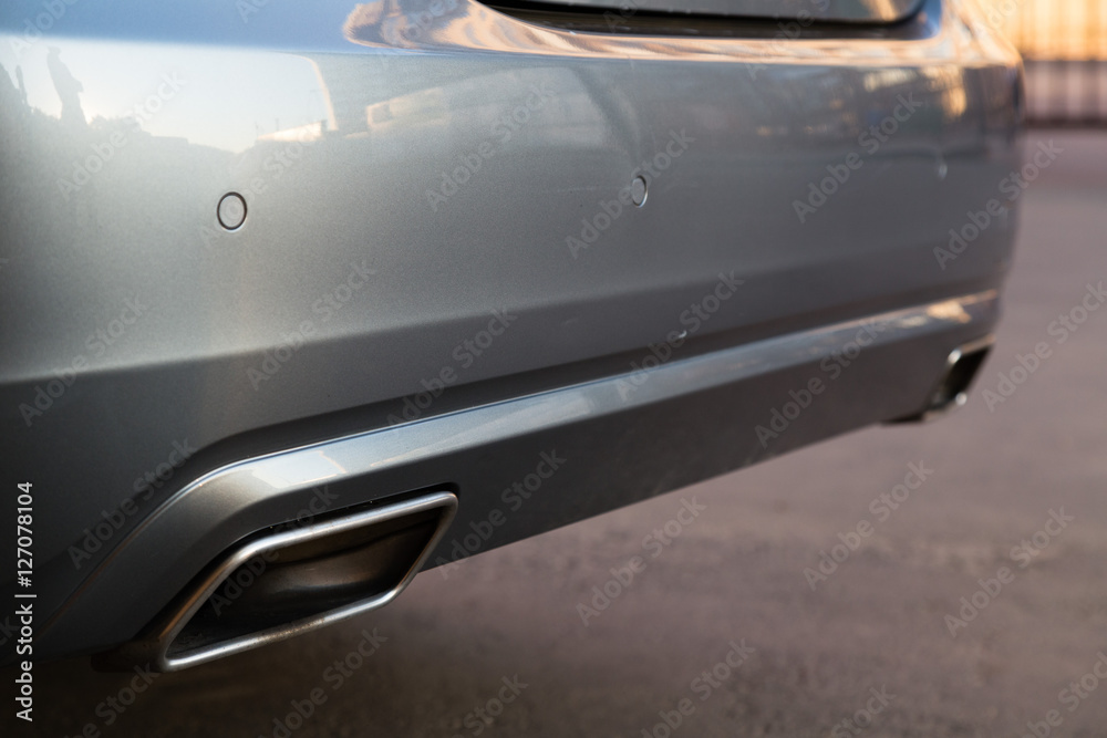 Exhaust system opening of famous german luxury car. Parking sensors also shown. Exhaust system opening of famous german luxury car. Parking sensors also shown.