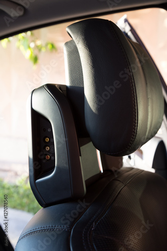 Car interior. Driver head support with embedded media system photo