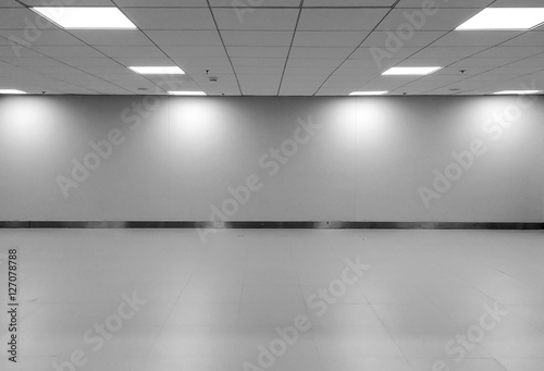 Perspective view of Empty Space Classic Monotone Black White Office Room with Row Ceiling LED Light Lamps and Lights Shade on Wall for Gallery Interior / Template to Mock Up Display Office Furniture