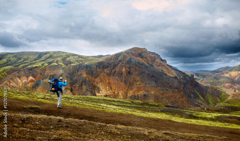 hiker on the trail in the Islandic mountains. Trek in National Park Landmannalaugar, Iceland