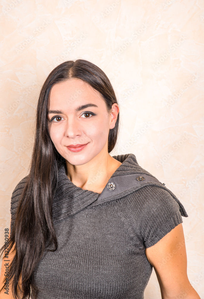 Woman with long black hair sitting at a sofa Woman with long black hair sitting at a sofa