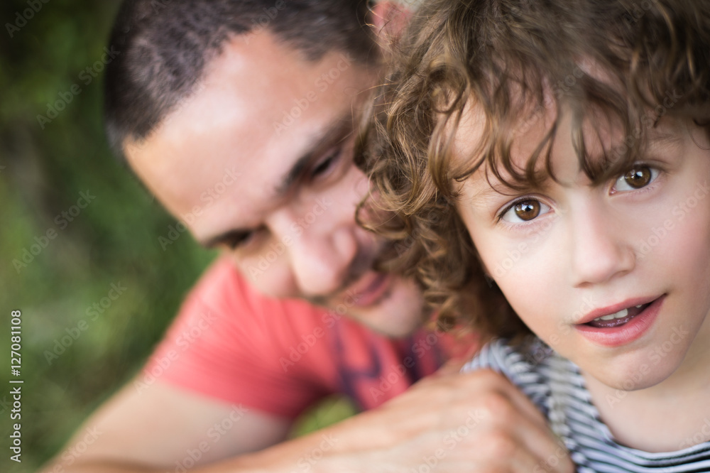 Young father with his son. Sunny summer nature. Young father with his son. Sunny summer nature.