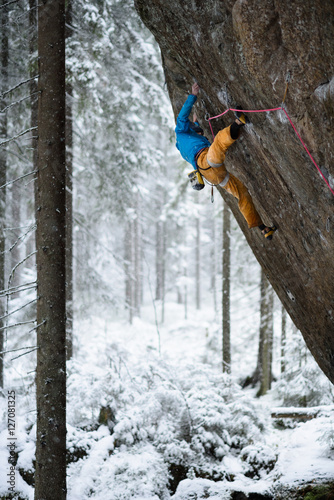Rock climber, professional athlete, climbing in Karelian mountains. Extreme sports.
