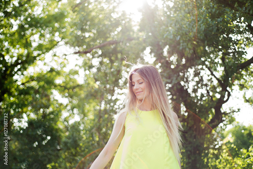 Beautiful young woman with long blonde hair. Sunny summer.