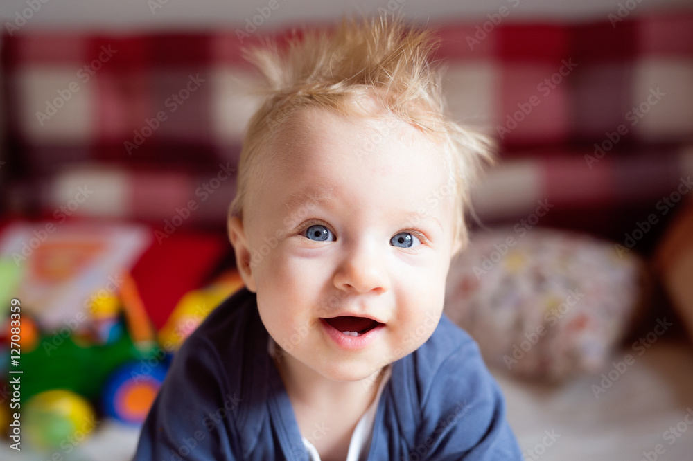 Little baby boy with spiky hair crawling on bed. Little baby boy with spiky hair crawling on bed.