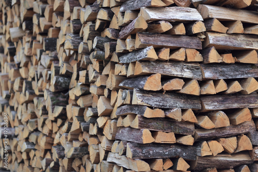 chopped firewood stacked for storage for the winter. background texture chopped firewood stacked for storage for the winter. background texture