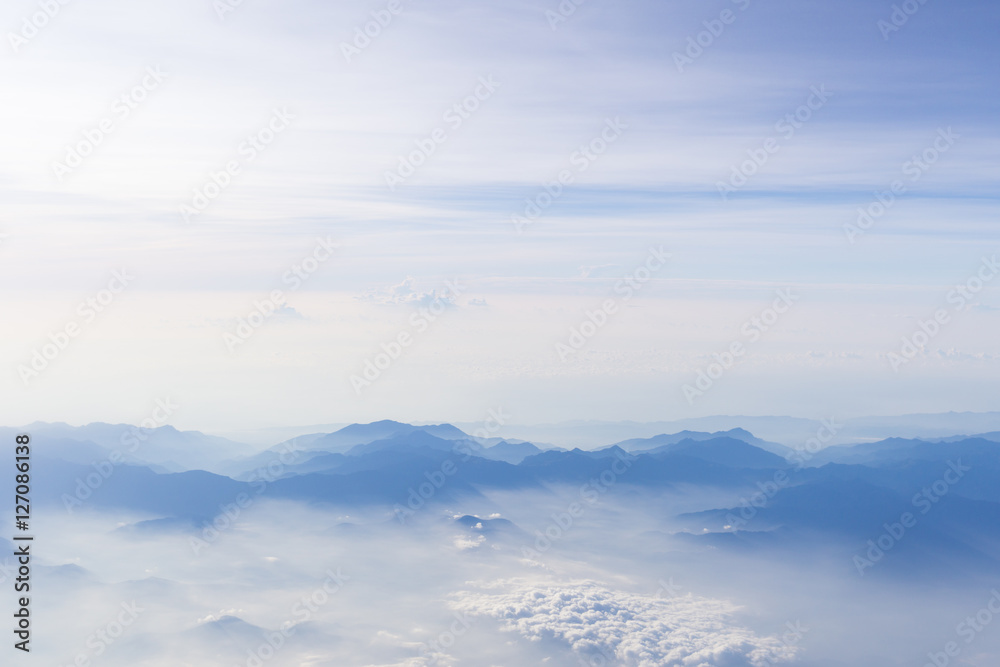 Blue sky and mountains view from airplane stylized hipster background with copyspace Blue sky and mountains view from airplane stylized hipster background with copyspace