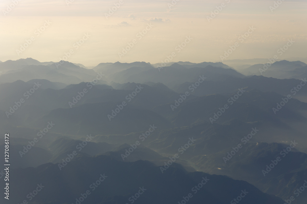 Blue sky and mountains view from airplane stylized retro vintage hipster background with copyspace