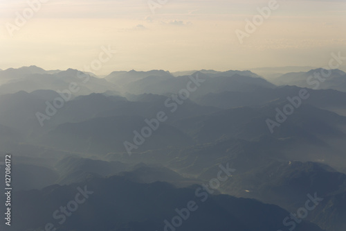 Blue sky and mountains view from airplane stylized retro vintage hipster background with copyspace