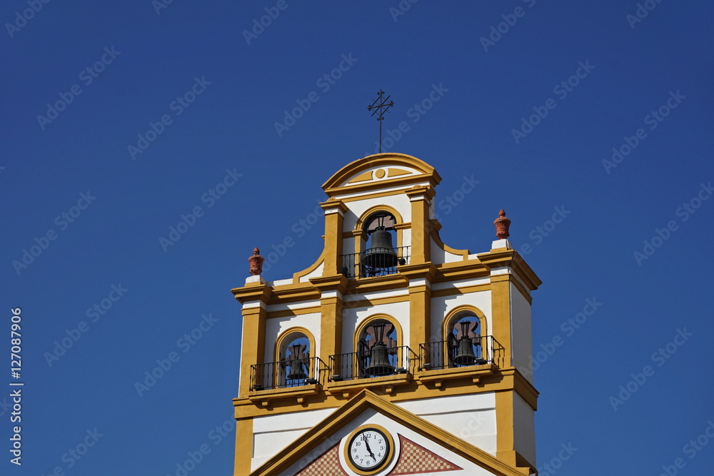 Top of the church in the town of La Linea de la Concepcion in southern Spain as a typical Spanish bell tower, symbol of Spanish religious architecture and design 