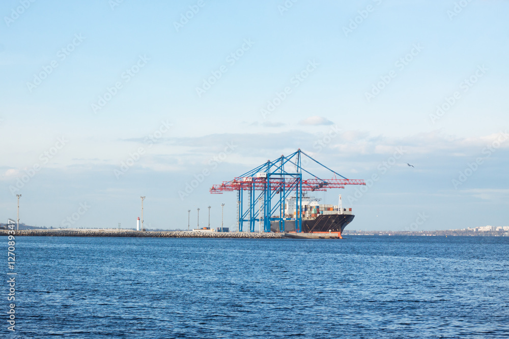 landscape with loading of Heavy cargo ship in sea port
