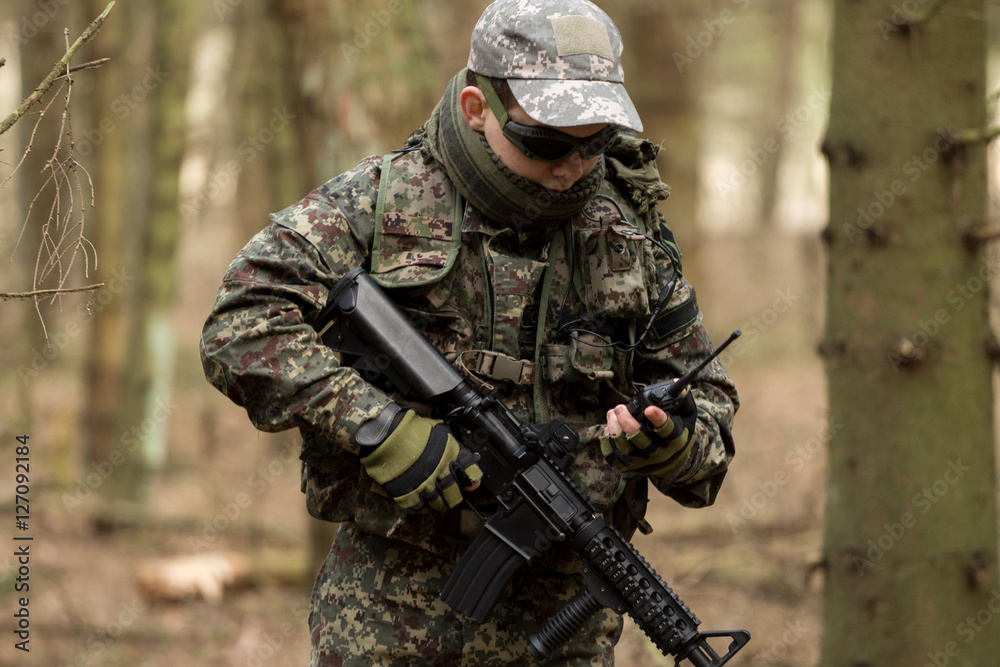 soldiers in the coniferous forest with a gun, aiming ready for battle soldiers in the coniferous forest with a gun, aiming ready for battle