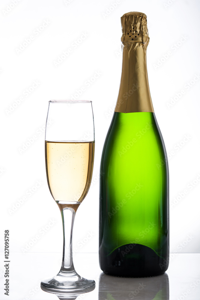 Champagne bottle and cup on white background
Champagne bottle and cup on white background
