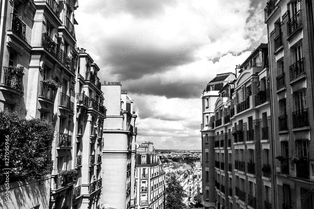 Fototapeta premium Black-white photo of view from Montmartre to summer Paris and beautiful cloudy sky. Paris, France.