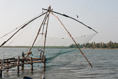 Fishermen using rudimentary wooden net for fishing in Goa India