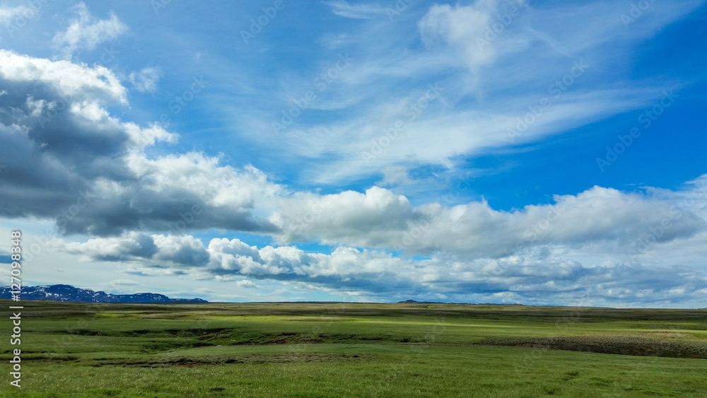 Iceland Landscape with clouds in blue sky and mountains in distance