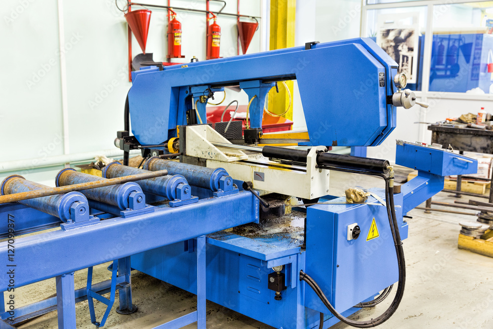 Semi-auto band saw in mechanical workshop Semi-auto band saw in mechanical workshop
