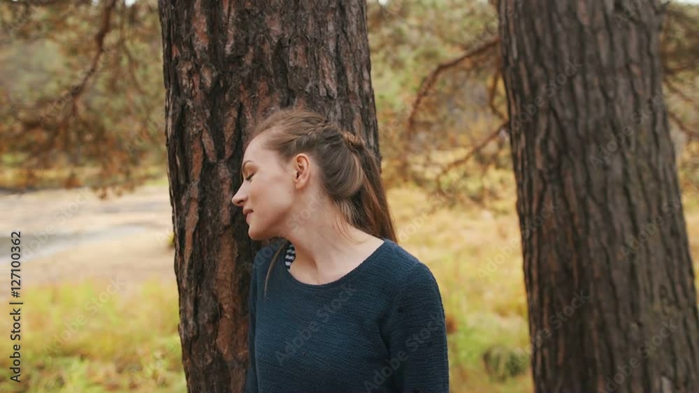 Romantic girl walks through the forest dreams with pleasant and smiles. Autumn Romantic girl walks through the forest dreams with pleasant and smiles. Autumn