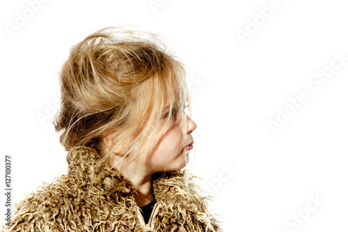 Tableau sur toile Disheveled preschooler girl with long hair dressed in fur coat