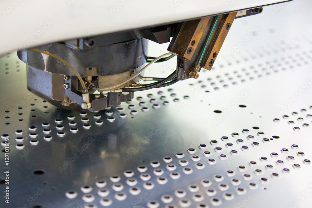 Rotation Punching & Machine in action. Metal perforating industrial machine. Stock Photo | Adobe Stock