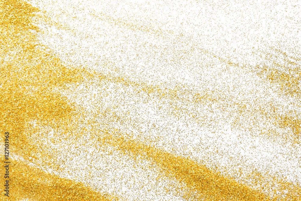 Golden glitter sand texture on white, abstract background.