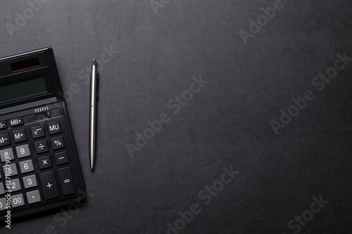 Office leather desk table with calculator, pen photo