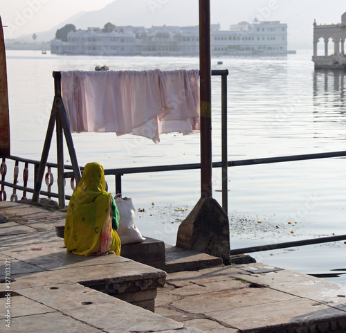 Femme indienne en sari jaune au bord du lac à Udaipur, Inde photo