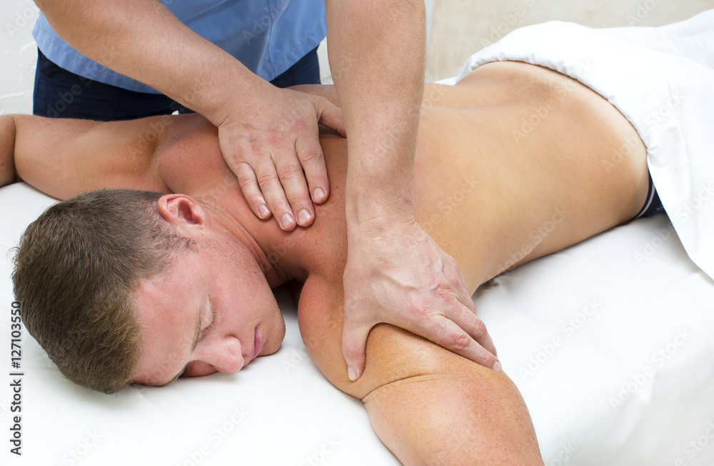 Young man on wellness treatments sports massage Young man on wellness treatments sports massage