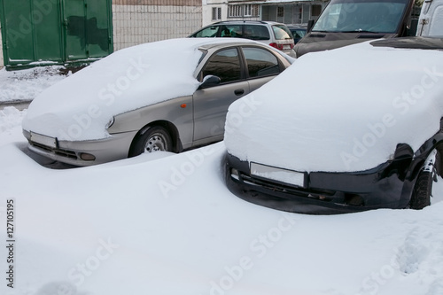 Cars covered in snow
