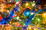 Abstract festive background with bokeh effect. Christmas tree and garland