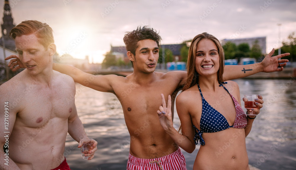 Young people together by the lake having fun Young people together by the lake having fun