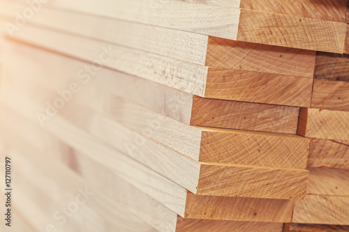 Wood timber construction material for background and texture. close up. Stack of wooden bars. small depth of field