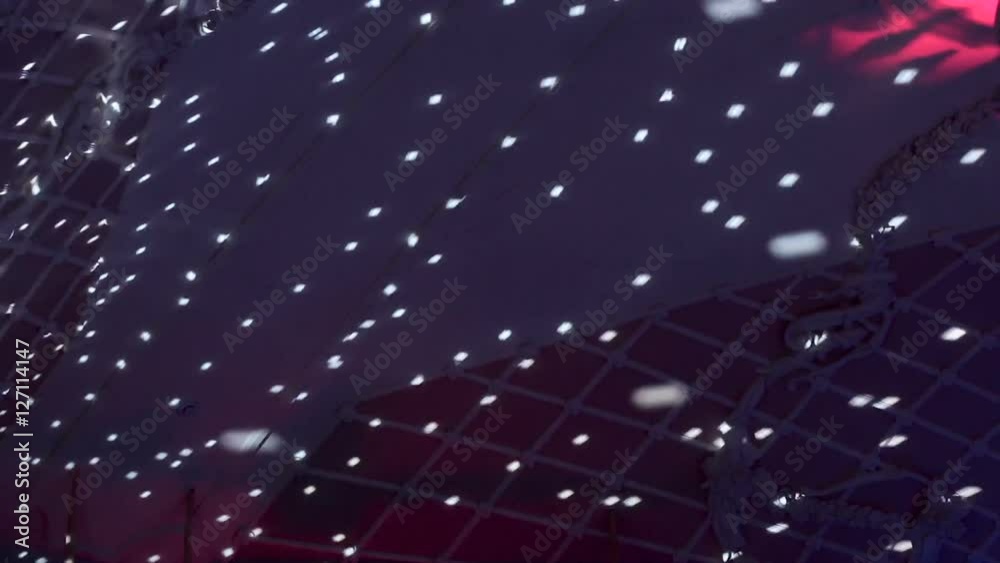 reflection of light from a mirror ball in the large white hall