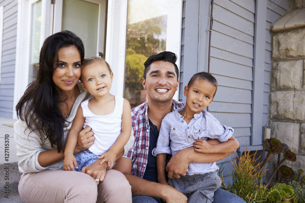Portrait Of Family Sitting On Steps Outside Home Portrait Of Family Sitting On Steps Outside Home