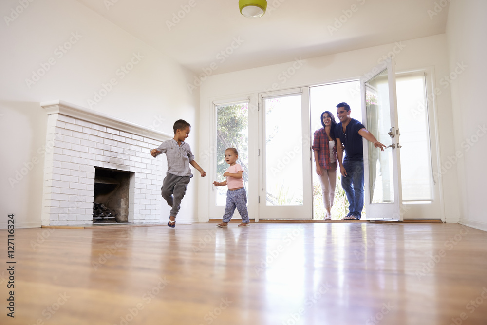 Excited Family Explore New Home On Moving Day Excited Family Explore New Home On Moving Day