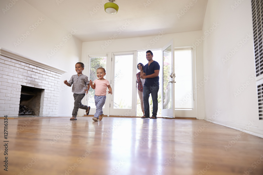 Excited Family Explore New Home On Moving Day