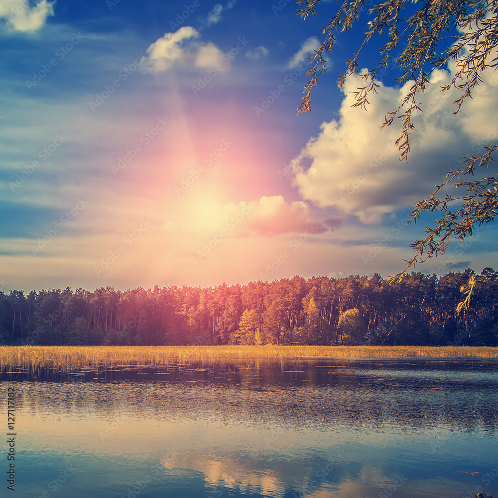 Beautiful Nature view of lake and summer landscape.  sky with clouds and sun over the water. use as background. instagram toning effect