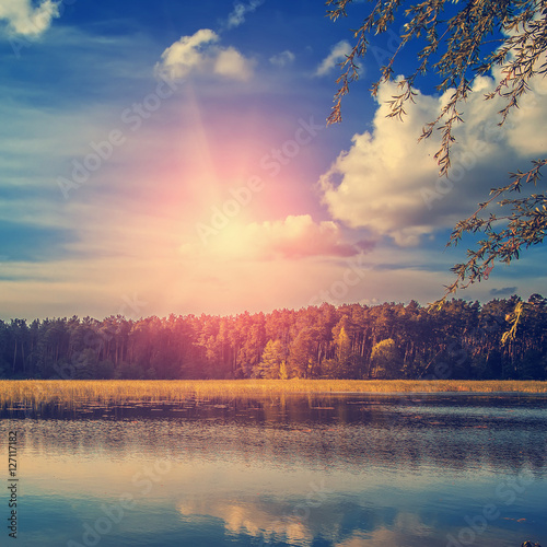 Beautiful Nature view of lake and summer landscape. sky with clouds and sun over the water. use as background. instagram toning effect