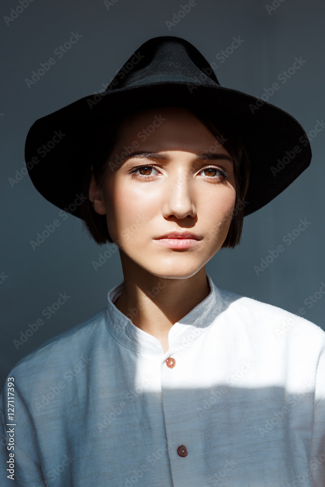 Portrait of young beautiful brunette girl in black hat. Portrait of young beautiful brunette girl in black hat.