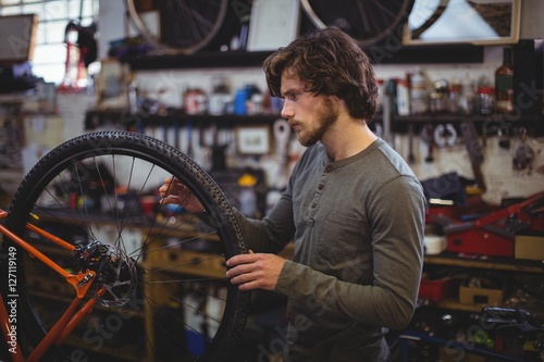 Mechanic examining a bicycle wheel