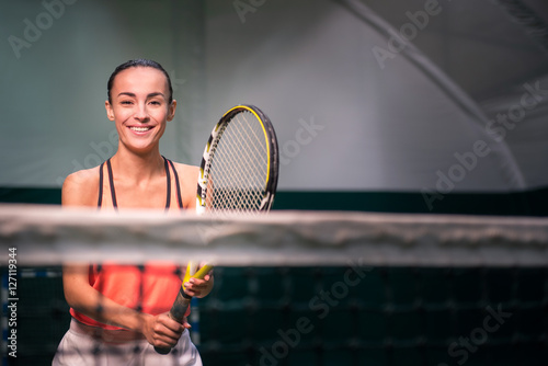 Smiling positive ypiung woman playing tennis © Viacheslav Yakobchuk