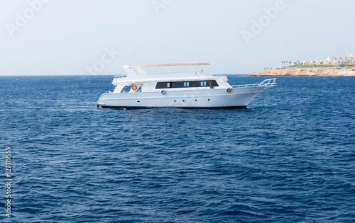 View of the sea with white floating yacht photo