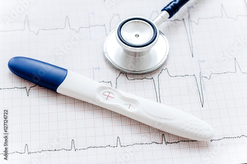 Positive pregnancy test with stethoscope photo