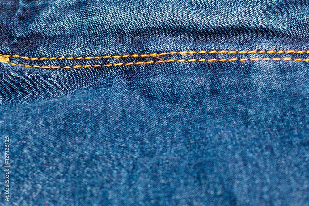 Blue jean or denim on wooden desk,make pattern background,make from cotton Blue jean or denim on wooden desk,make pattern background,make from cotton